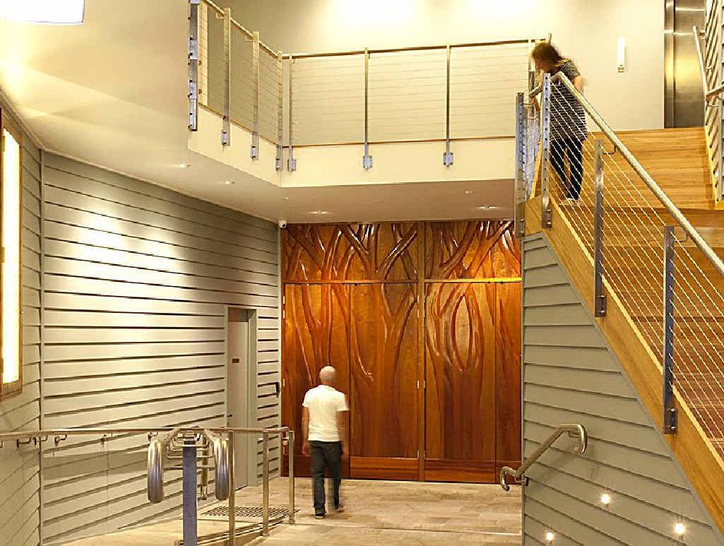 INNOVATION: Hand-carved Wootha red cedar entry doors are a feature of Maleny Community Centre. INNOVATION: Hand-carved Wootha red cedar entry doors are a feature of Maleny Community Centre.